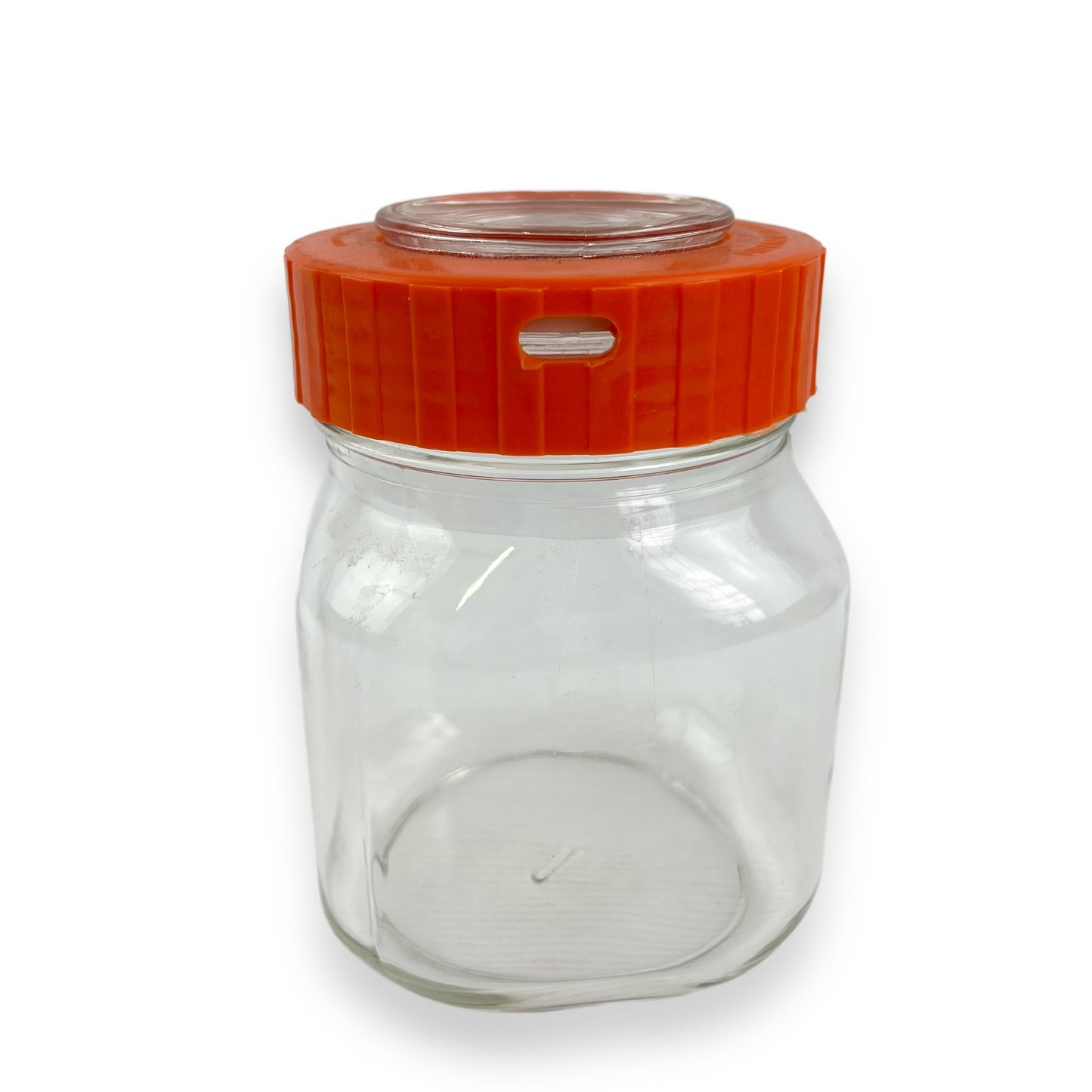 Clear glass jar orange lid