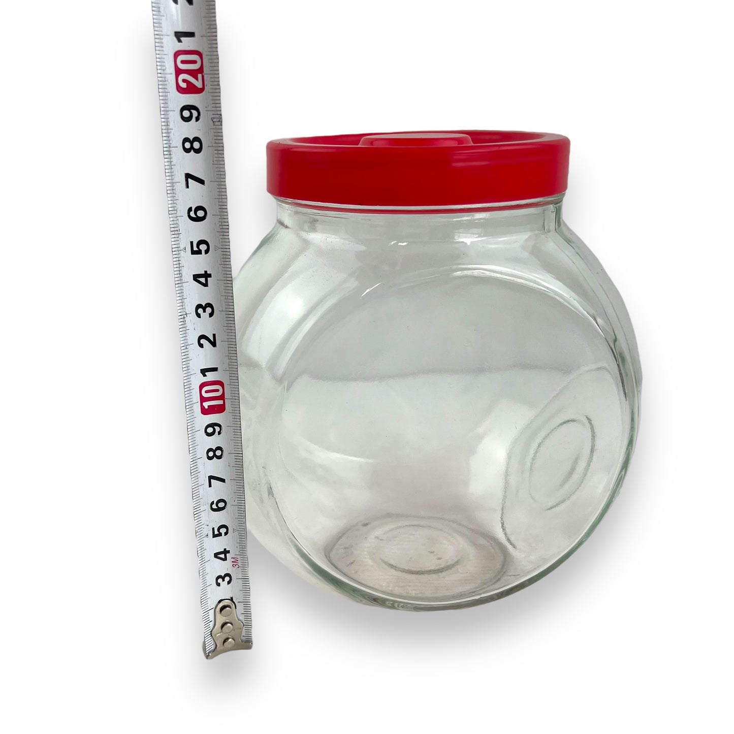 Red lid round glass storage jar