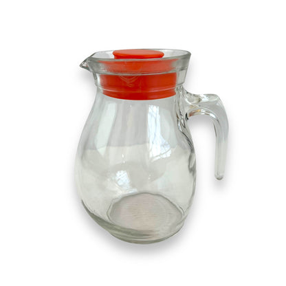 Clear jug with red plastic lid