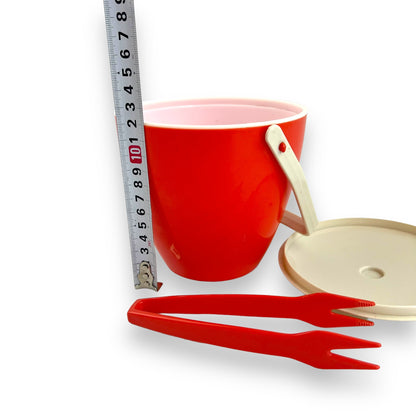 Orange red plastic ice bucket with tongs