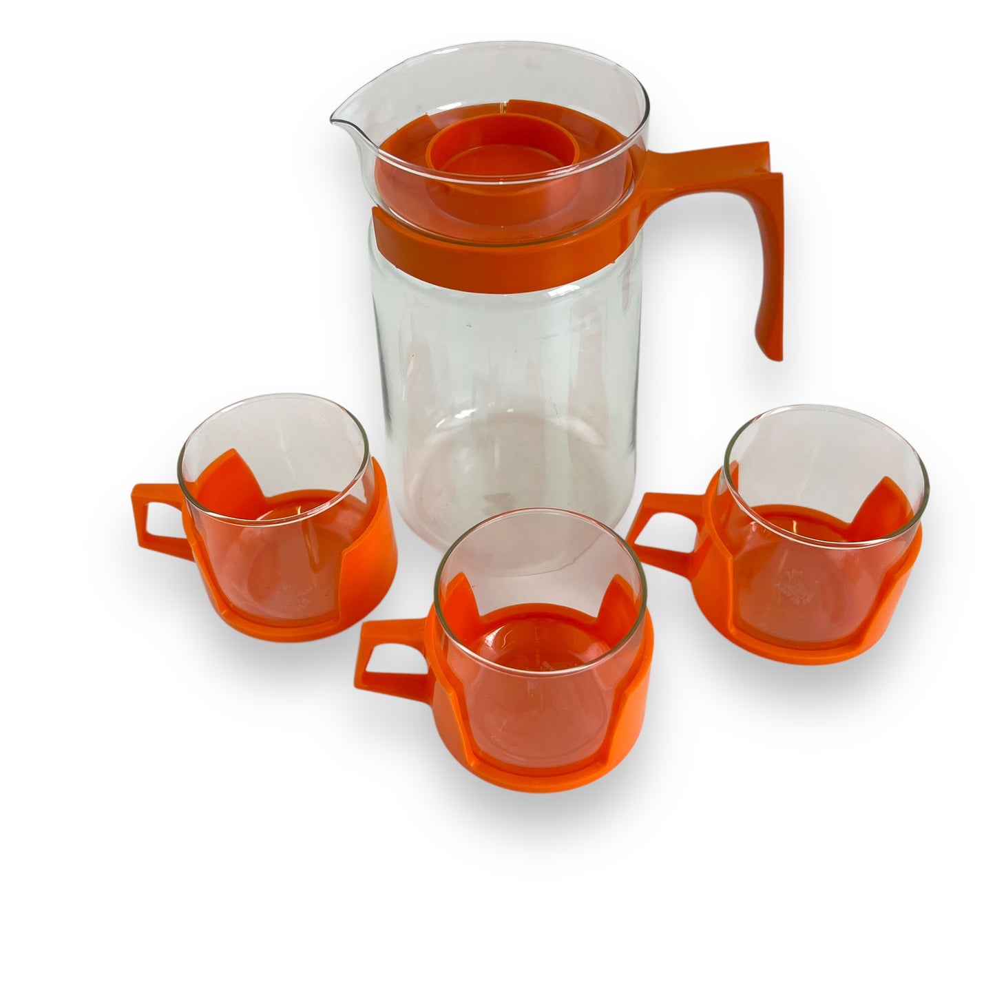 JAJ Pyrex Clear glass jug & 3 cups with orange plastic handles and lid.