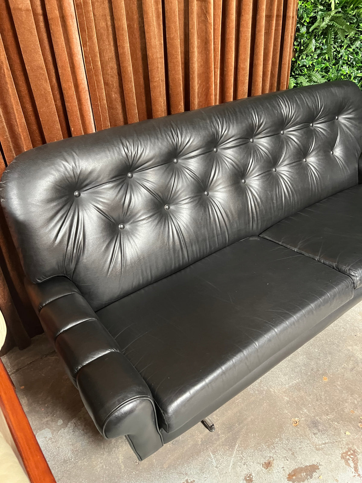 Black Button-Tufted Three-Seater Lounge with Chrome Legs