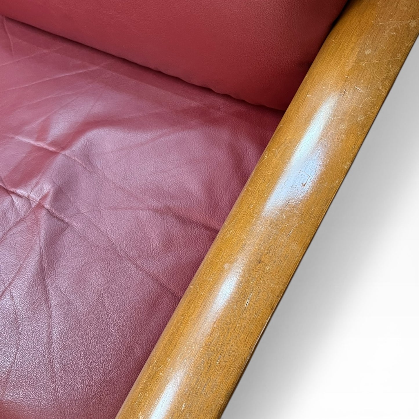 Two Seater Lounge with Sculpted Curved Timber Armrests & Burgundy Leather Cushions