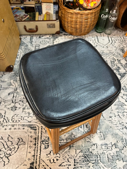 Wooden stool with black top