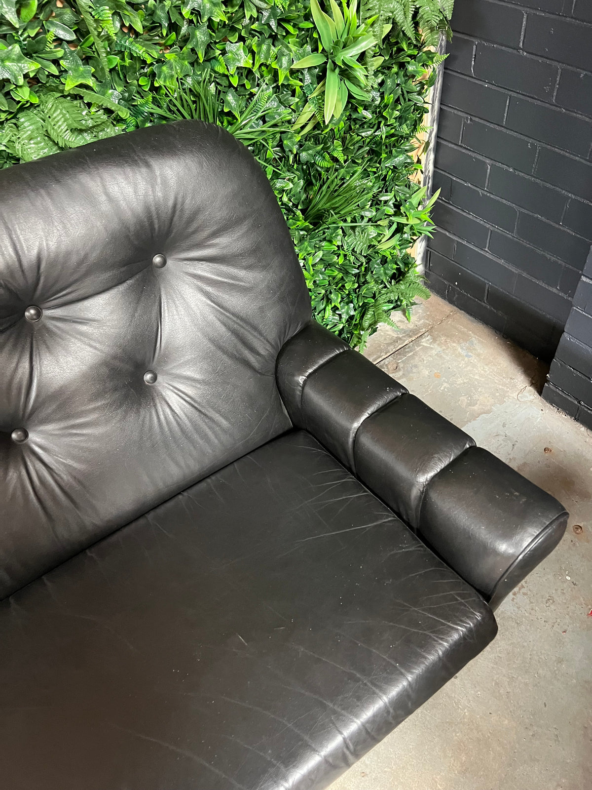 Black Button-Tufted Three-Seater Lounge with Chrome Legs