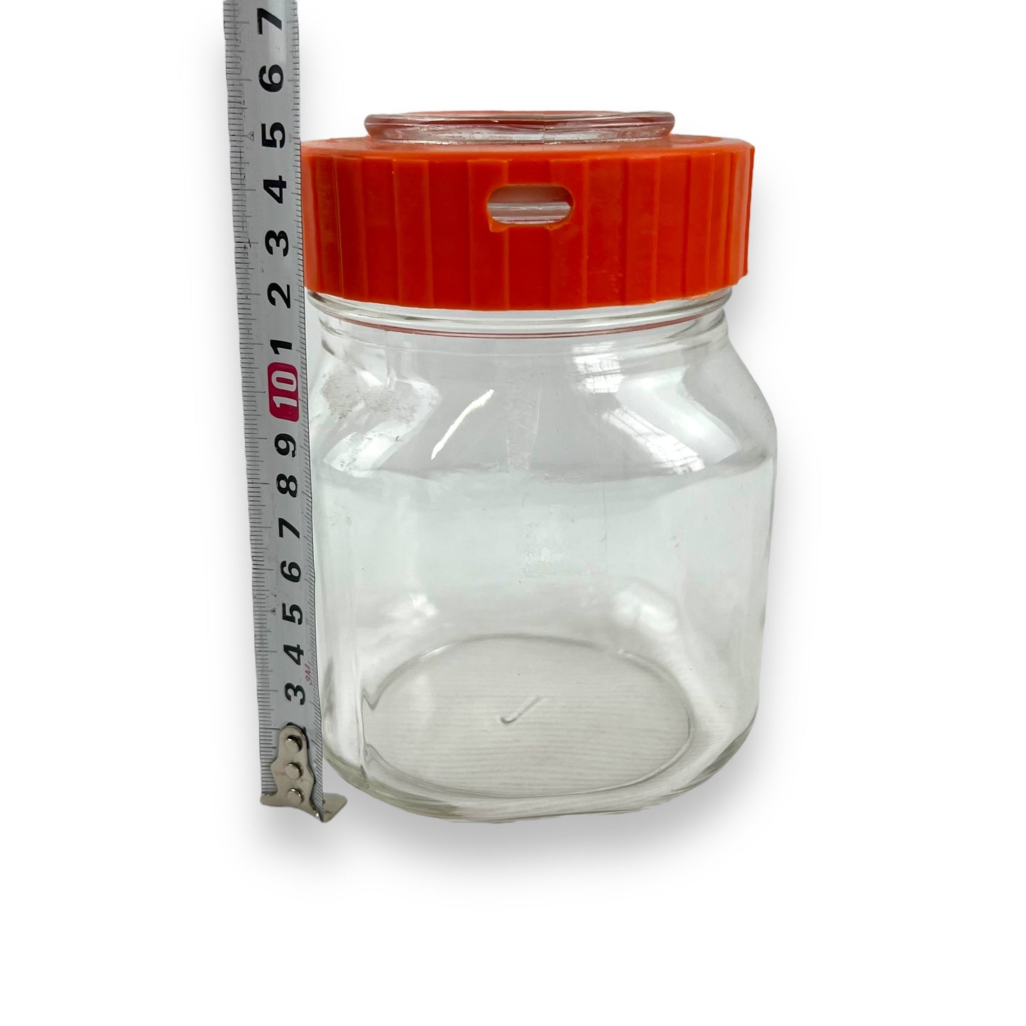 Clear glass jar orange lid