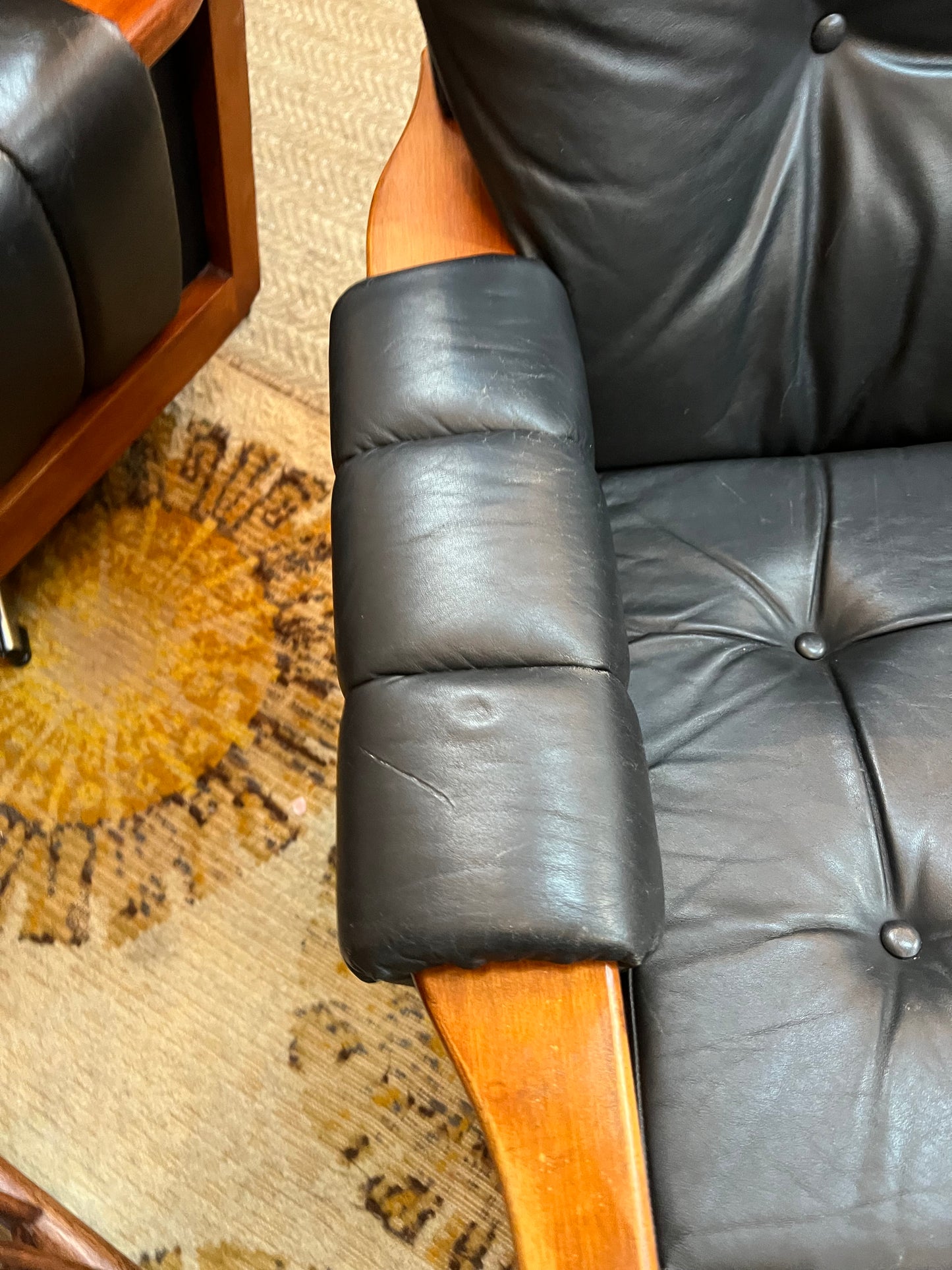 1. Mid-Century Black Leather Swivel Lounge Chair