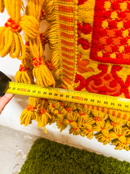 Large orange and yellow patterned wool rug