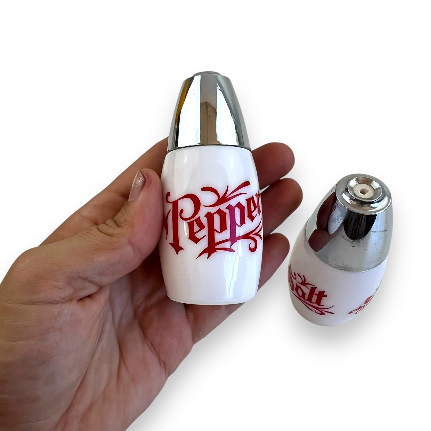 White with red writing and chrome top salt and pepper shaker set