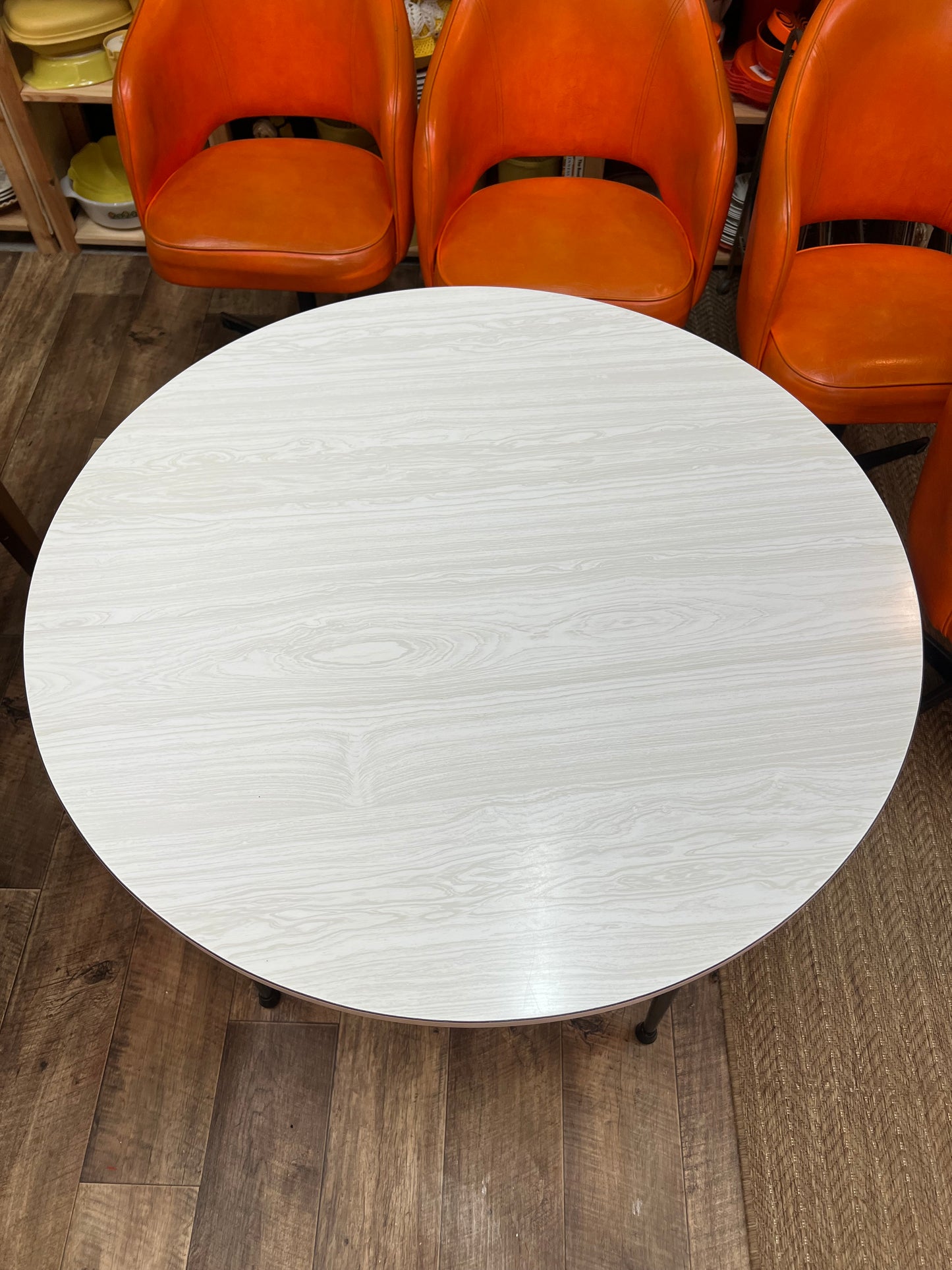 Namco Round Mid Century Dining Table with White Woodgrain Laminate Top and black steel legs