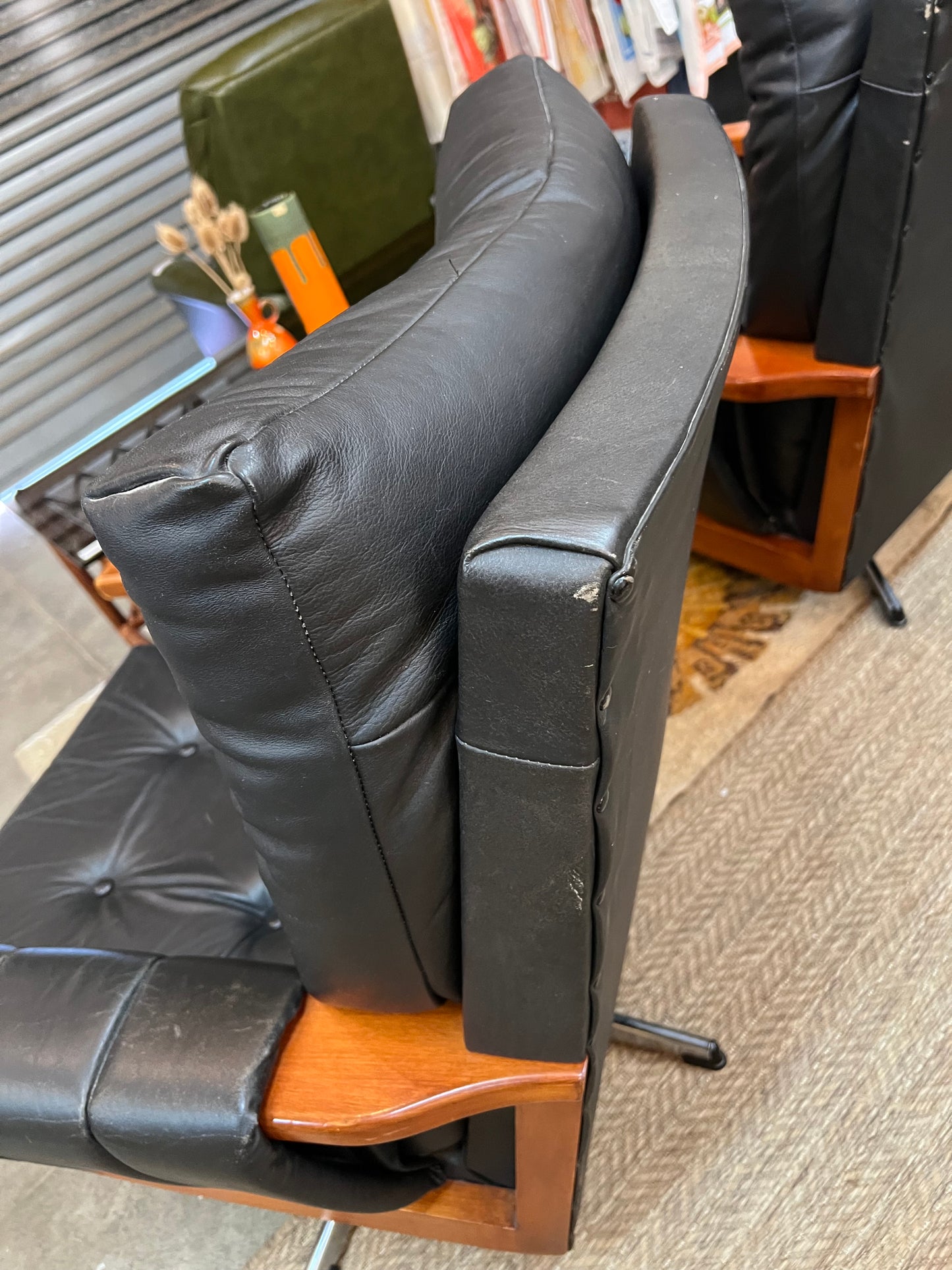 1. Mid-Century Black Leather Swivel Lounge Chair
