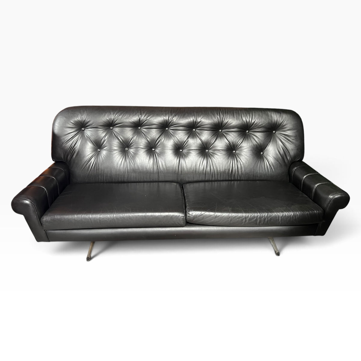 Black Button-Tufted Three-Seater Lounge with Chrome Legs