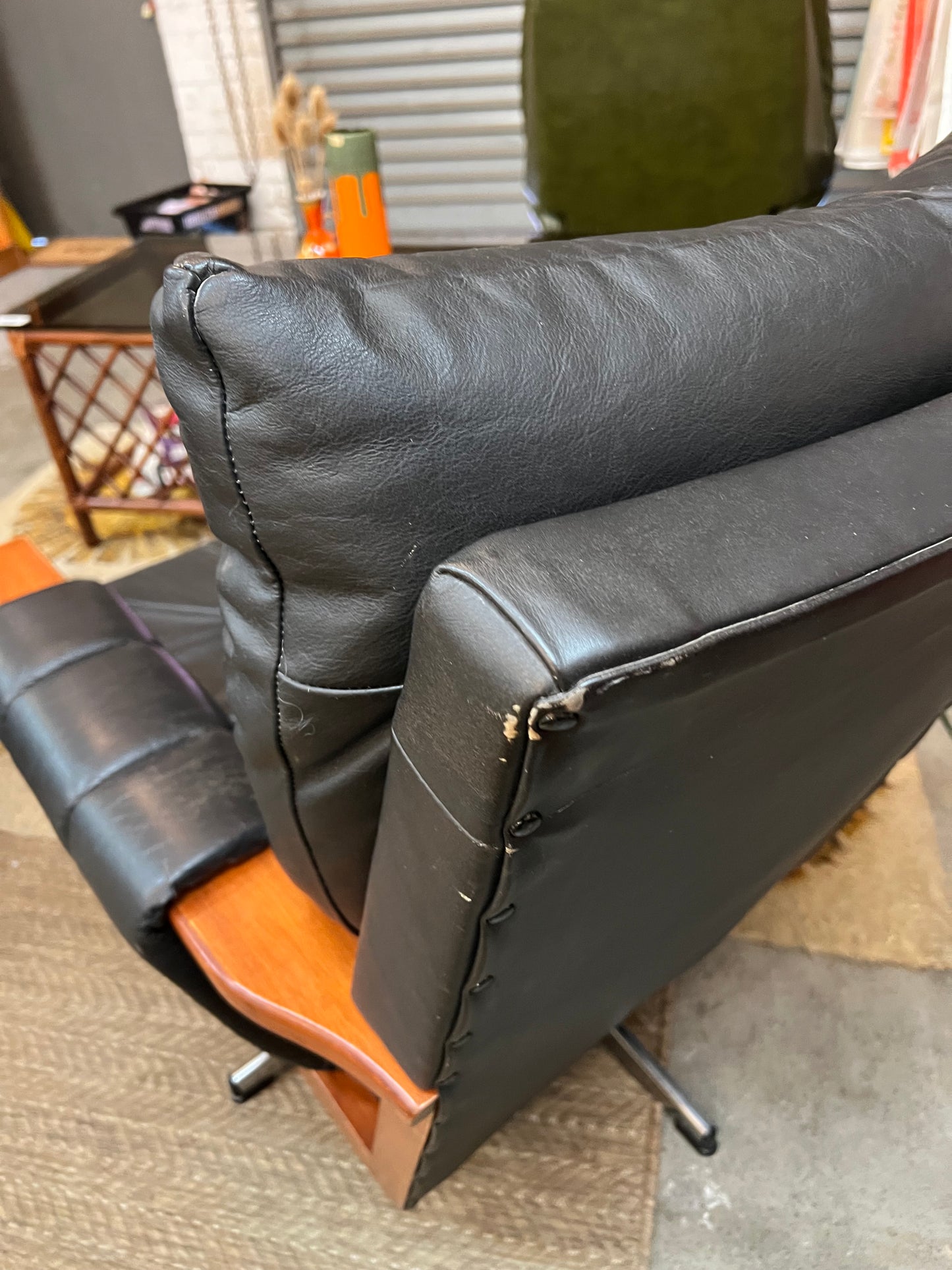 2. Mid-Century Black Leather Swivel Lounge Chair