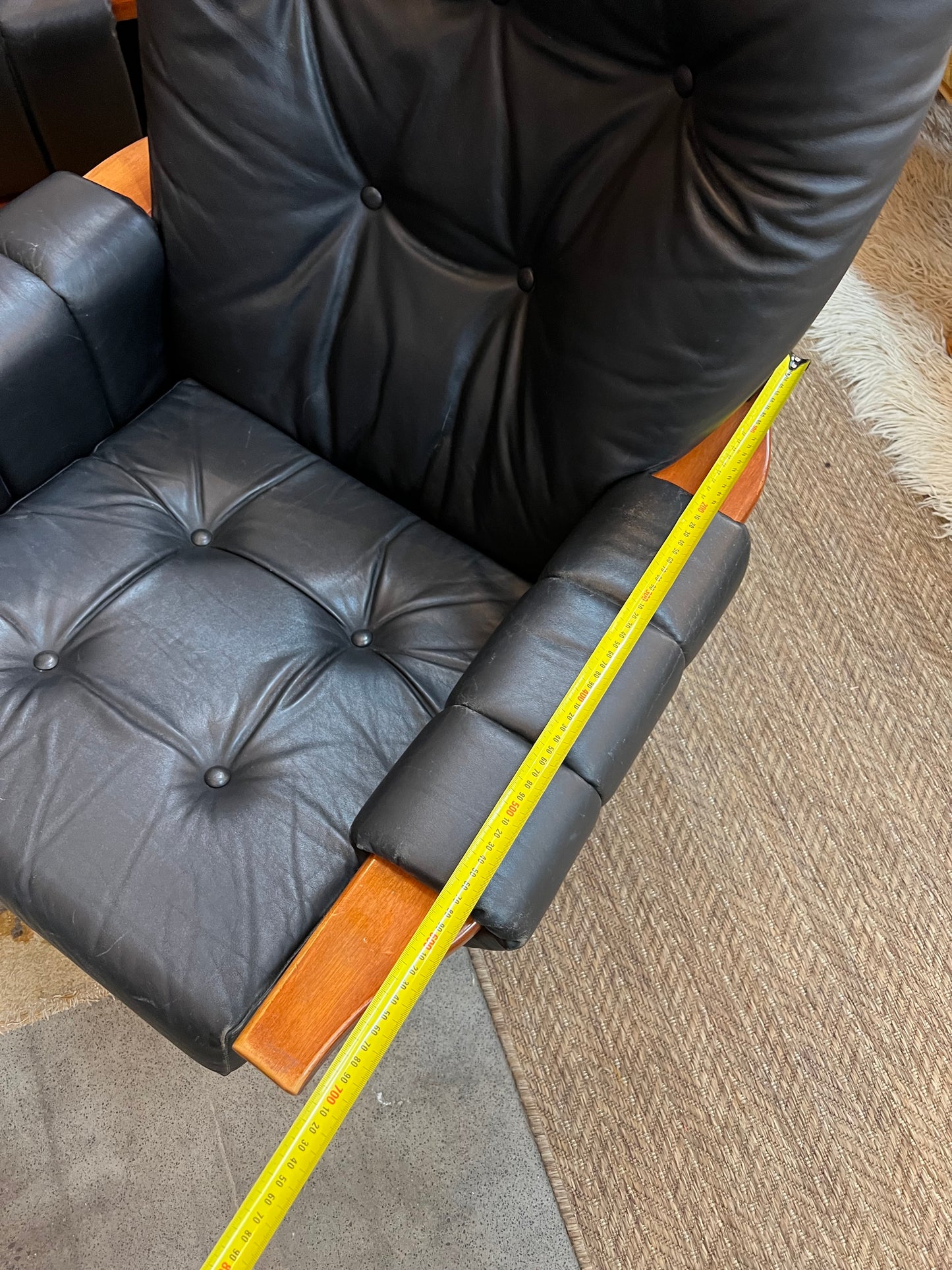 1. Mid-Century Black Leather Swivel Lounge Chair