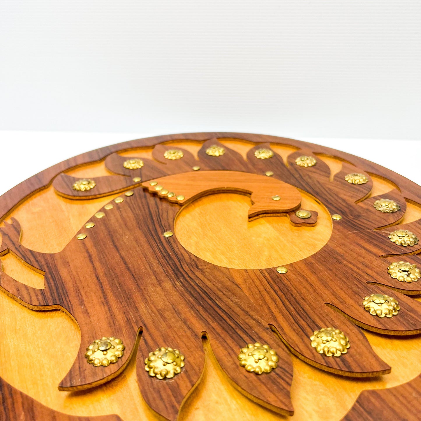 Wooden peacock cutout hanging circle artwork with gold Details.