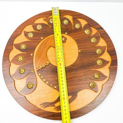 Wooden peacock cutout hanging circle artwork with gold Details.