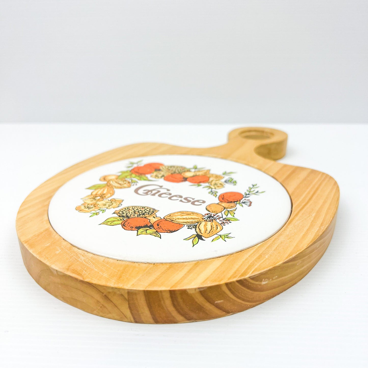 Vintage wooden chessboard with patterned cheese tile