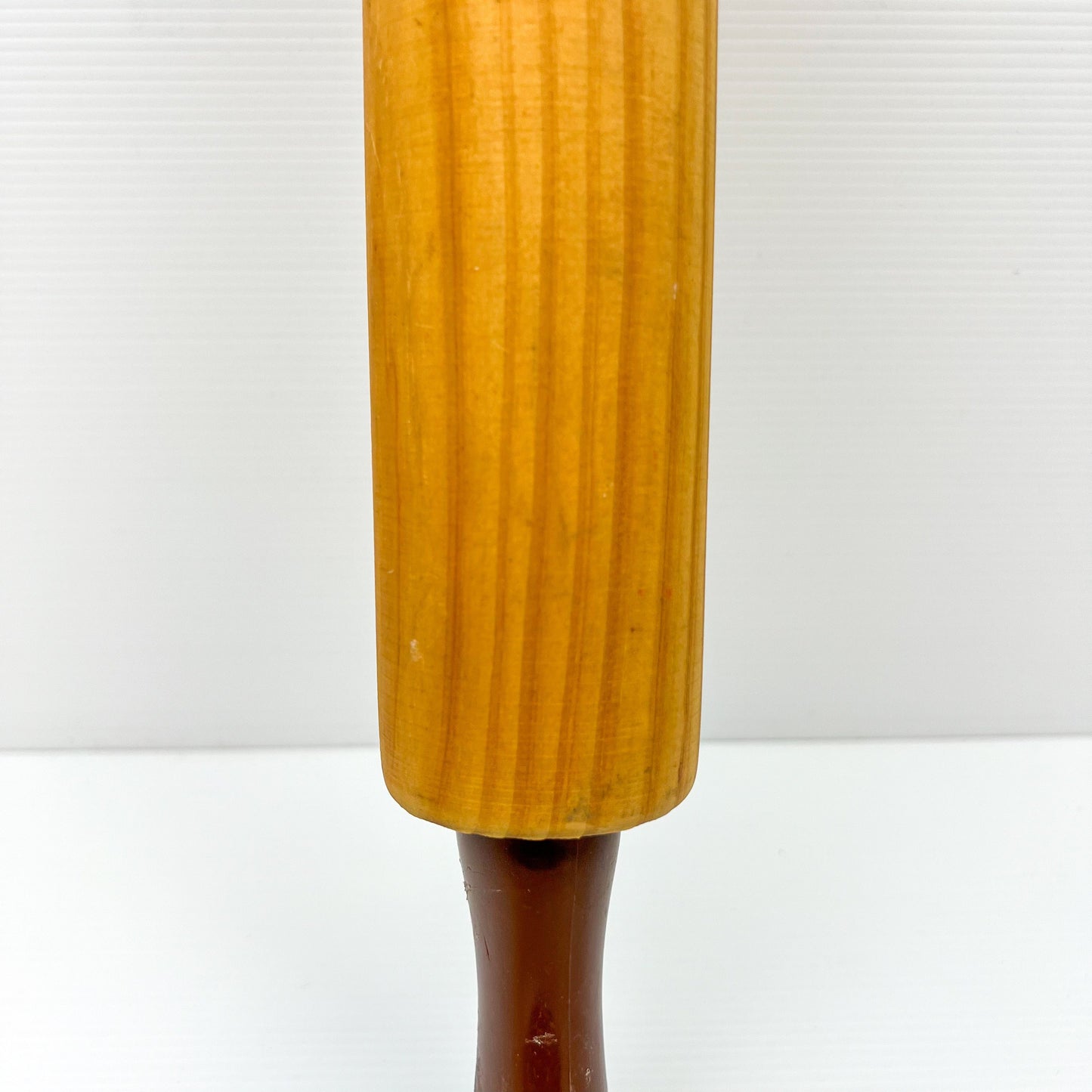 Wooden rolling pin with brown plastic handles