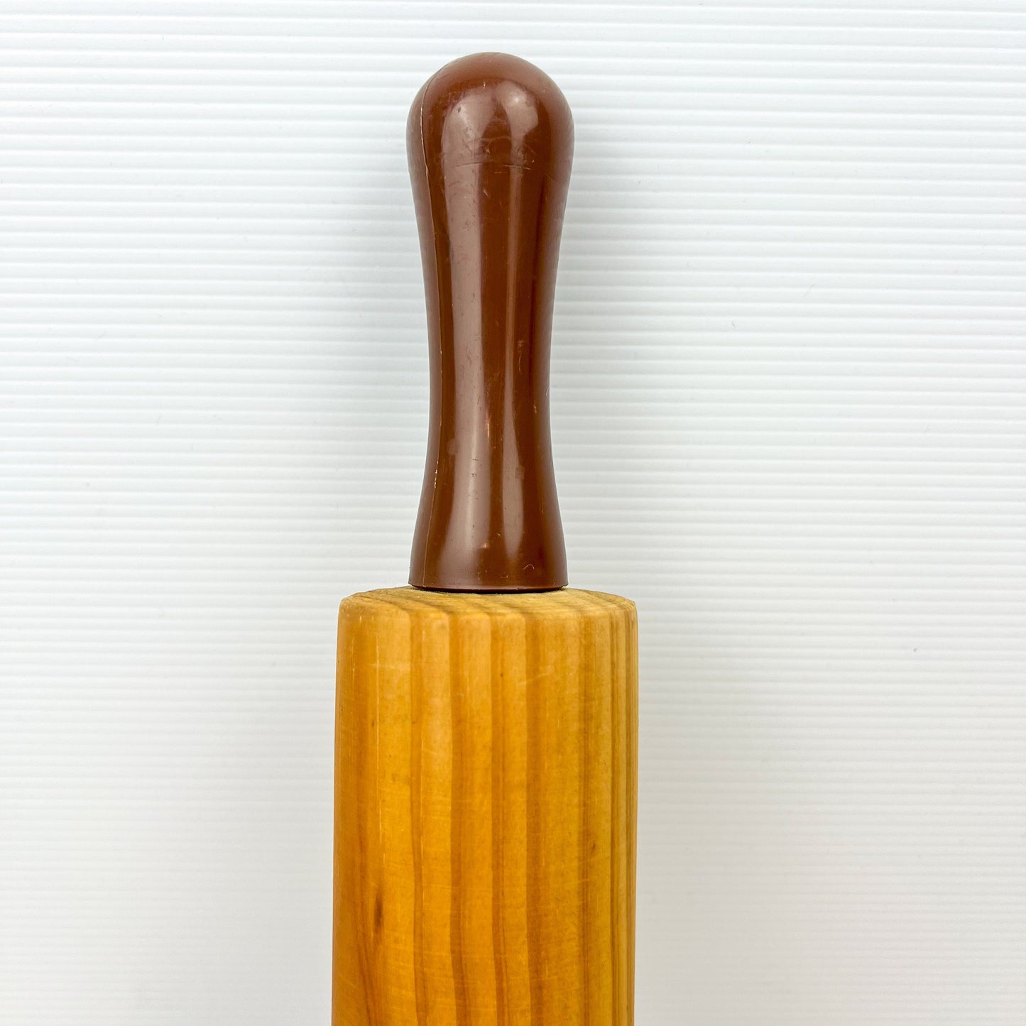 Wooden rolling pin with brown plastic handles