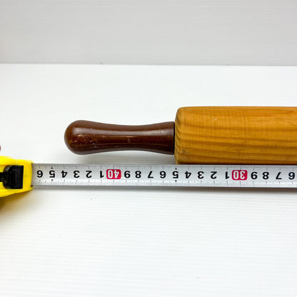 Wooden rolling pin with brown plastic handles
