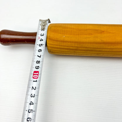 Wooden rolling pin with brown plastic handles